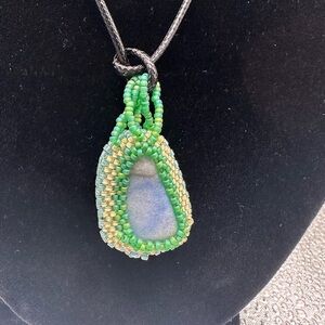 Handcrafted Larimar stone with glass beaded bezel.